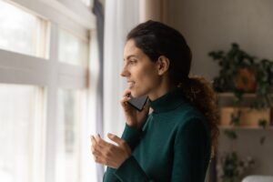 woman on a phone looking troubled - Insurance KPIs Customer Engagement
